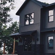 a large gray house with lots of windows