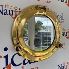 a mirror on the side of a wall that says naviflicace, located in front of a window