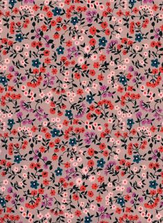 an image of a flowery fabric with red, blue and pink flowers