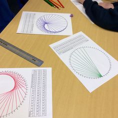 two children are sitting at a table with paper cut out and pencils next to them