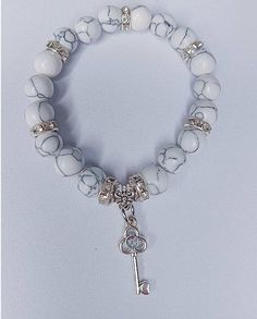 Beautiful white and grey marble bracelet with silver and cubic zirconia accents. Hanging silver key charm is so cute. A must. Dora Costume, White And Grey Marble, Marble Bracelet, Silver Key, Grey Beads, Beads Bracelet Design, Dora The Explorer, Bracelet Design, Gold Heart Necklace