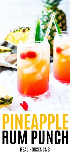 two pineapple rum punch cocktails in glasses with strawberries and pineapple garnish