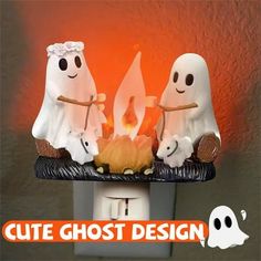 three ghost figurines sitting on top of a light switch with the words cute ghost design above them