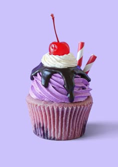 a cupcake with purple frosting and a cherry on top