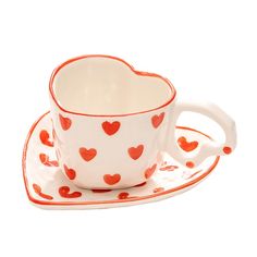 a cup and saucer with hearts on it