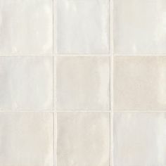 a white tile wall with several squares in it