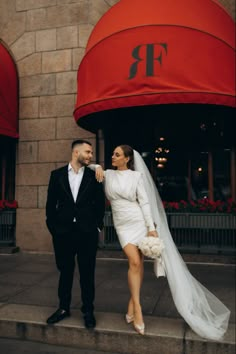 a bride and groom pose for a photo on their wedding day in front of the restaurant