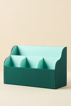 a green desk organizer with four compartments