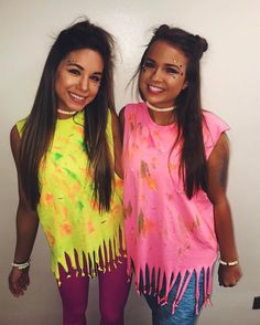 two young women standing next to each other wearing colorful clothing and smiling at the camera