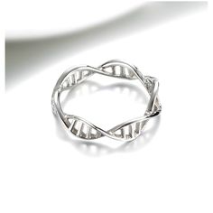 a silver ring sitting on top of a white surface