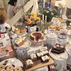 a table full of desserts and pastries for sale