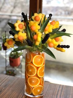 a vase filled with orange slices and flowers