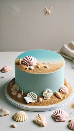 a blue cake with seashells and starfish on the top is sitting on a table