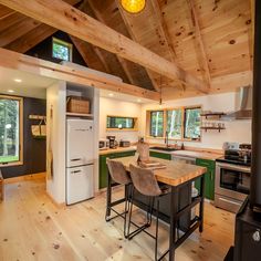 a kitchen with wood floors and green cabinets