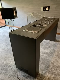 a dj's turntable sitting on top of a carpeted floor