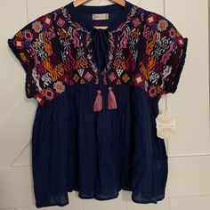 This Is A Size Small Nwt Altar’d State Shirt. It Has A Beautiful Multi-Colored Pattern On The Top, Flowy Babydoll Bottom Half, And Has Ties With Multi Colored Tassels. Perfect For Summer! Navy Relaxed Fit Tops For Spring, Indigo Crew Neck Tops For Summer, Bohemian Blue Tops With Relaxed Fit, Blue Bohemian Relaxed Fit Tops, Bohemian Blue Relaxed Fit Tops, Navy Relaxed Fit Tops For Vacation, Blue Crew Neck Blouse For Beach, Indigo Short Sleeve Top For Spring, Navy Short Sleeve Blouse For Summer