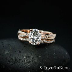 a diamond engagement ring on top of a rock