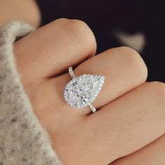 a woman's hand with a diamond ring on it