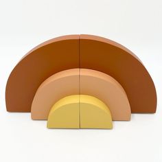 an orange and yellow sculpture sitting on top of a white floor