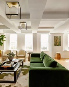 a living room filled with lots of green furniture