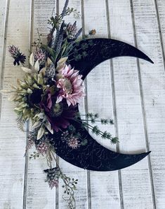 a flower arrangement sitting on top of the moon