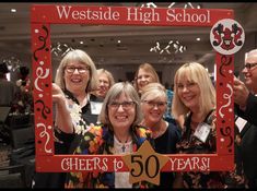 some people are posing for a photo in front of a sign that says, westside high school cheers to 50 years