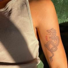 a woman with a tattoo on her arm