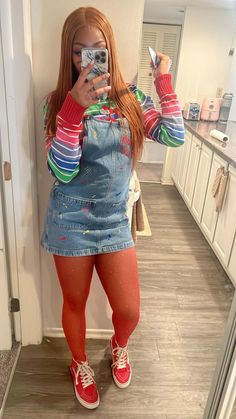 a woman taking a selfie in the mirror wearing red tights and colorful socks