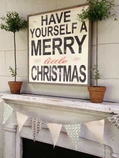 a fireplace mantle with potted plants on it and a merry sign above the mantel