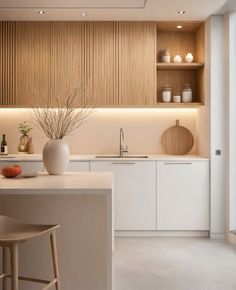 a modern kitchen with white cabinets and counter tops