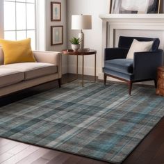 a living room filled with furniture and a rug on top of a hard wood floor