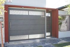 a modern garage door is shown in front of a house