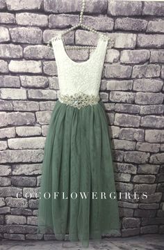 Beautiful Classic white and sage green Bohemian style Flower Girl dress.   A lined sleeveless white lace upper bodice, with a layered sage green tulle flowing skirt - the back of the bodice features a beautiful crossed, sheer eyelash lace back.  Complete with a diamante wrap around and tie satin ribbon sash.   Sash added to dress for ages 3/4 years plus.   Available in ages 6 months to 12 years - the sizes are given in average ages for UK and USA children with average body size for that age grou Jr Bridesmaid Dresses Bohemian, Teen Flower Girl Dresses, Older Flower Girl, Sage Flower Girl Dress, Classic Bohemian Style, Full Length Tulle Skirt, Bohemian Flower Girl Dress, Kids Bridesmaid Dress, Green Flower Girl Dresses