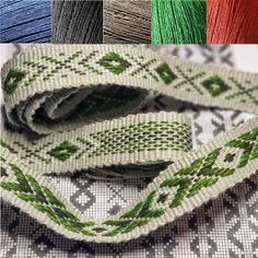 four different colors of thread on a white table cloth with green and red designs in the center