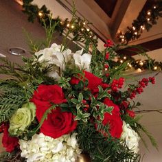 a vase filled with red and white flowers