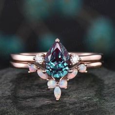 an engagement ring with a blue topazte and white opals