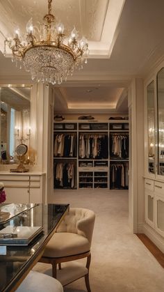 a walk in closet with chandelier and dressing room furniture