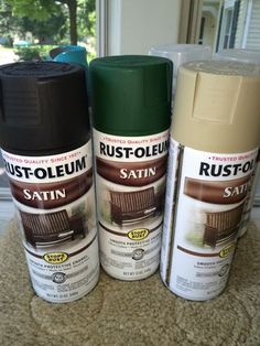 three cans of rustoleum sitting next to each other on a carpeted floor