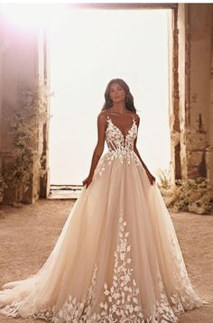 a woman standing in front of an archway wearing a wedding dress