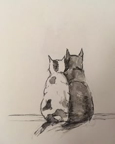 two cats are sitting next to each other