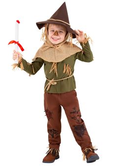 a little boy dressed up as a scarecrow holding a stick and wearing a hat