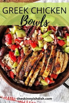 a bowl filled with chicken, cucumber and tomato salad on top of a wooden table