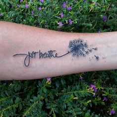 a person's arm with a dandelion tattoo that says, just breathe