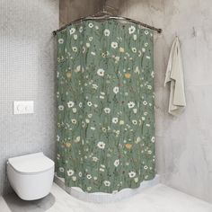 a bathroom with a green shower curtain next to a white toilet and wall mounted sink