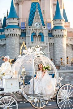 a bride and groom are riding in a horse - drawn carriage at the disney world