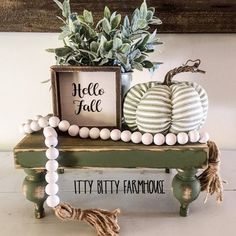 two pumpkins are sitting on a bench with a sign that says hello, fall