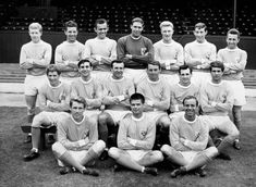 an old black and white photo of men soccer team posing for a group photograph in front of the bleachers