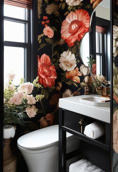 a bathroom with floral wallpaper and black walls