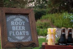 a sign that says root beer floats next to some bottles and candy canes on a table