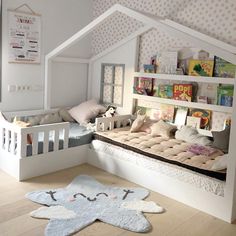 a child's room with a bed, bookshelf and toys